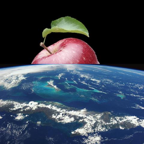 an apple rising up above the Earth from space