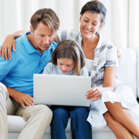 parents with daughter and a laptop