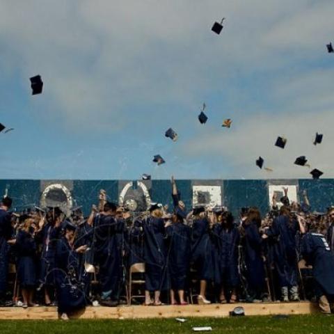 graduates tossing their caps
