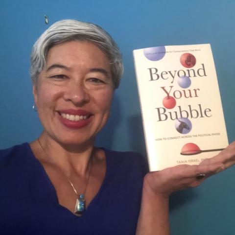 Tania Israel with her book "Beyond Your Bubble"