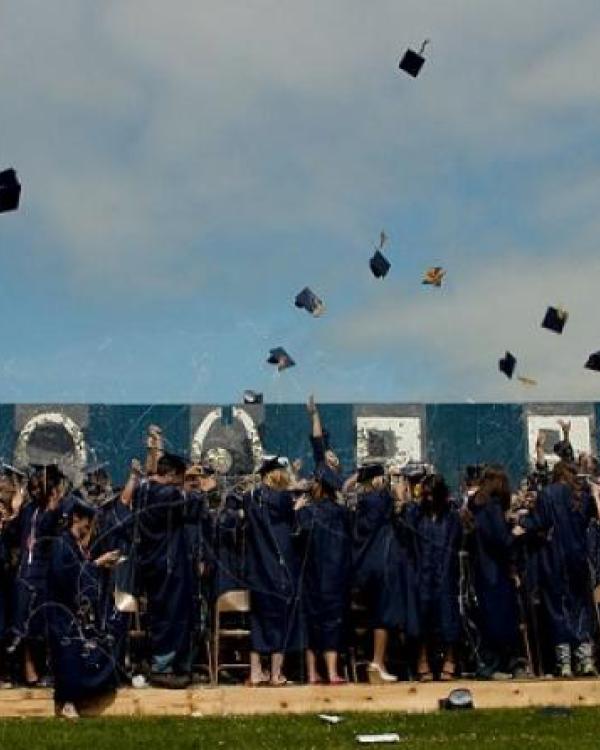 graduates tossing their caps 