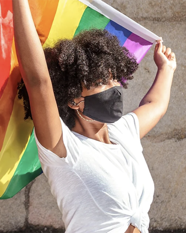person holding gay pride flag 