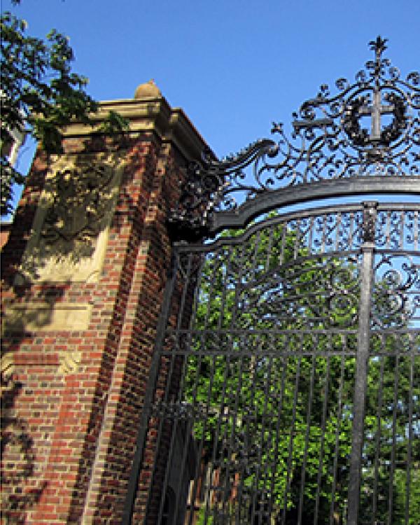 Dean Jewffrey Milem with a photo of Harvard Gate, as he was a guest lecturer for the school 