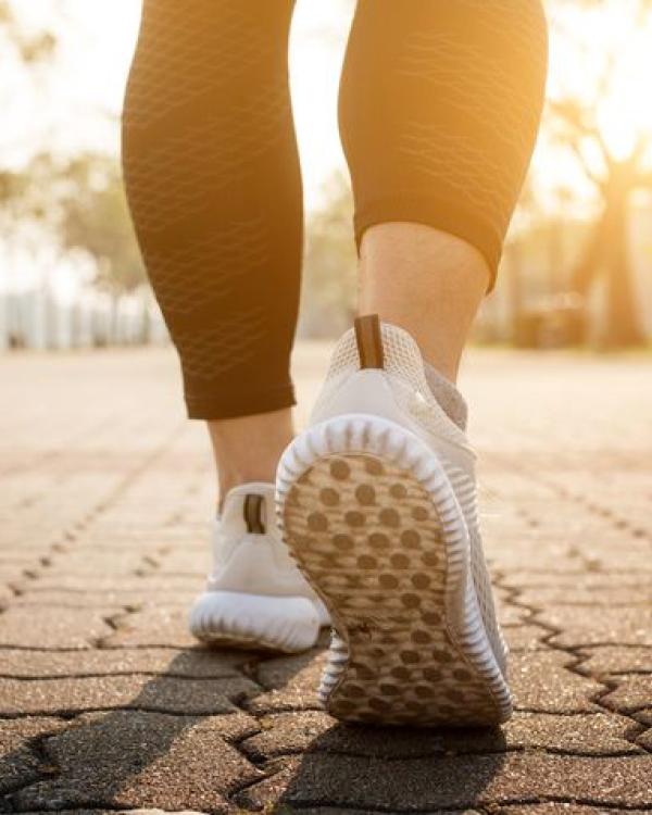 close-up of feet running on road 