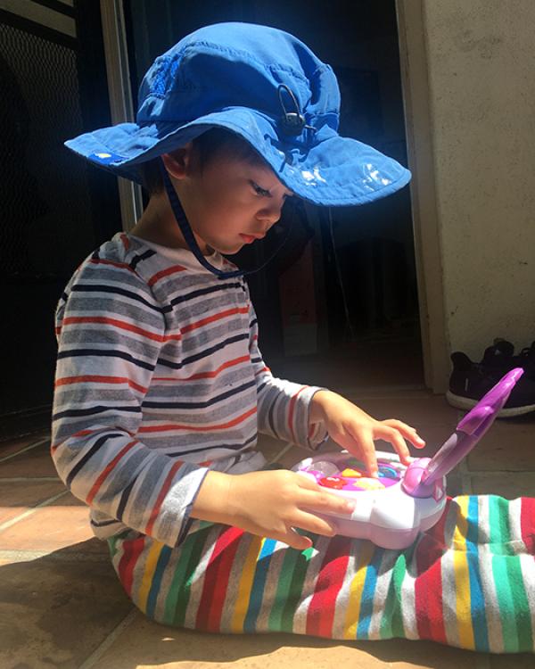 child working on toy computer 